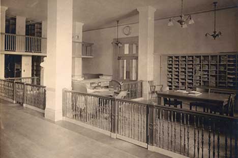 Photo of interior with short railings, tables, and shelves