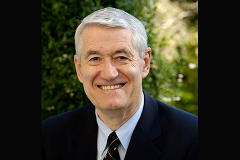 Portrait of man with silver hair smiling back at viewer