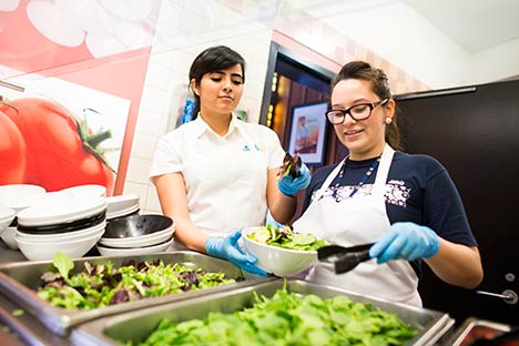 Student workers preparing salad