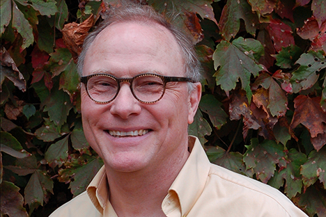 Man wearing glasses and smiling back at viewer
