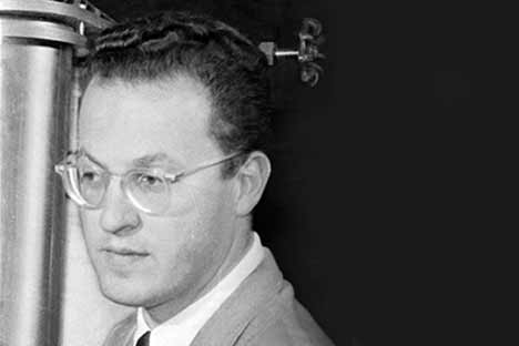Black and white portrait of middle-aged man with dark hair and glasses