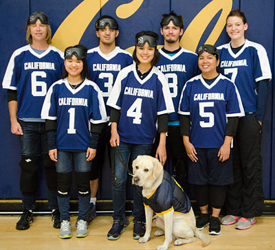 Students with guide-dog wearing blue jerseys