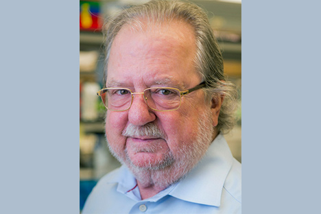 Older male wearing glasses and light blue shirt