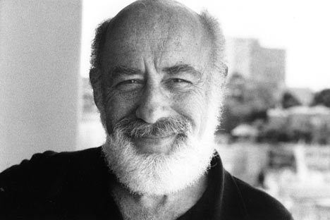 Smiling man with balding head and beard