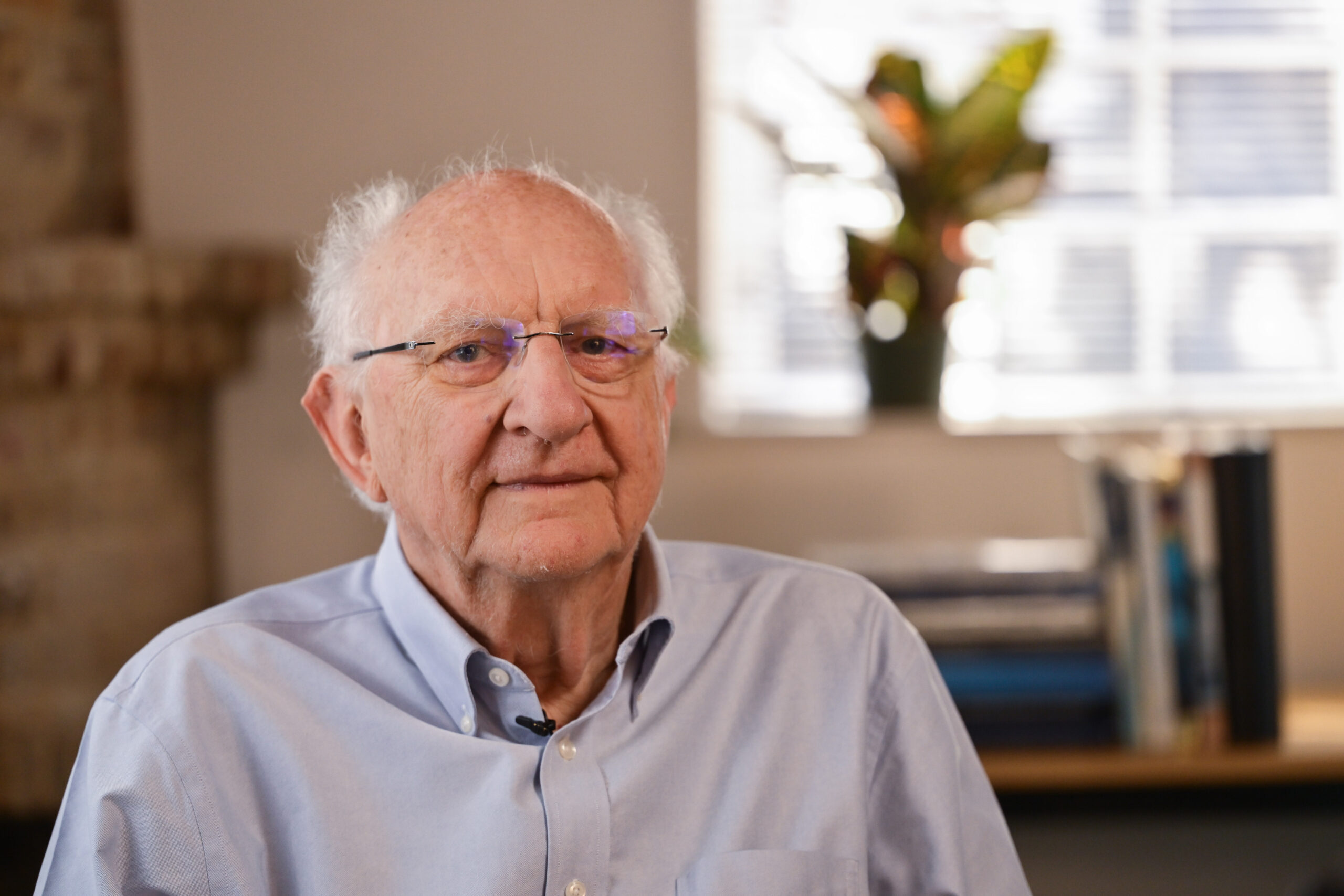 John Clarke sits at his desk in his office
