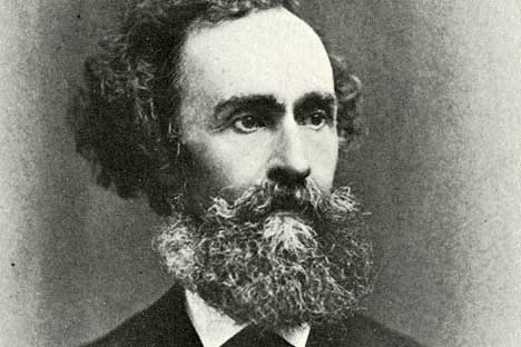 black and white portrait of man with full beard, mustache, and wavy hair