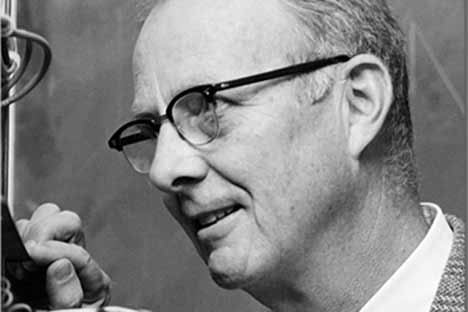 Man wearing glasses looking at something carefully