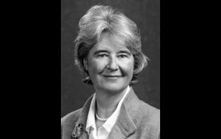 Black and white portrait photo of woman wearing pearls