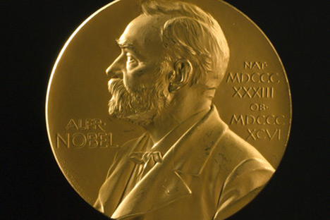 Round gold medallion with profile of man.
