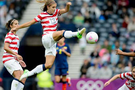 Soccer player kicking the ball mid air
