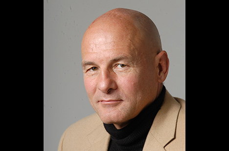 Bald man looking back at viewer