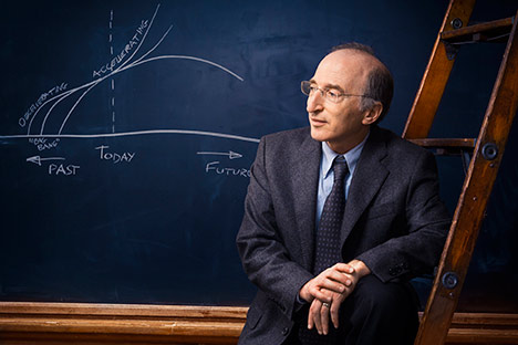 Man leaning on ladder with blackboard diagram in background
