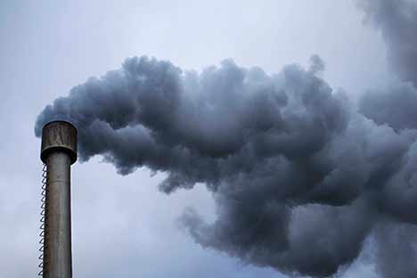 billowing smoke coming from a smokestack
