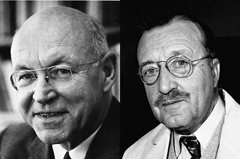 Black and white photos of two men wearing glasses and looking back at viewer