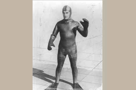 Figure wearing a wetsuit and swim fins